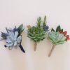 Three boutonnieres-blue, berries.