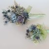 Two succulent bridesmaids bouquets with blue thistle.