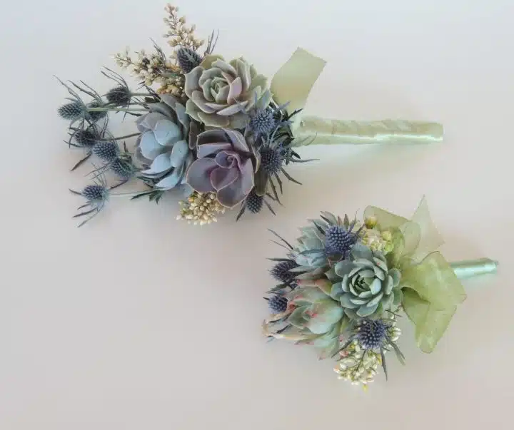 Two succulent bridesmaids bouquets with blue thistle.