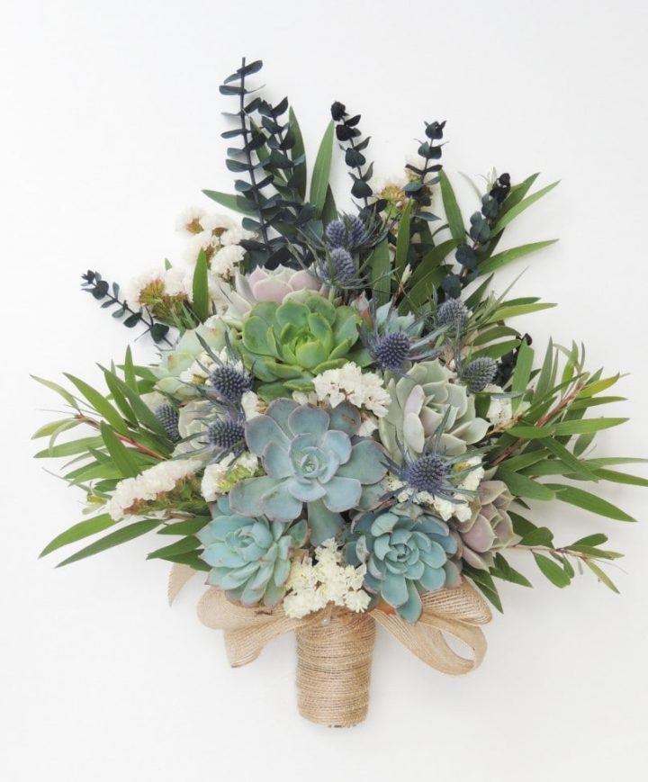 Succulent bouquet with blue thistle and baby eucalyptus