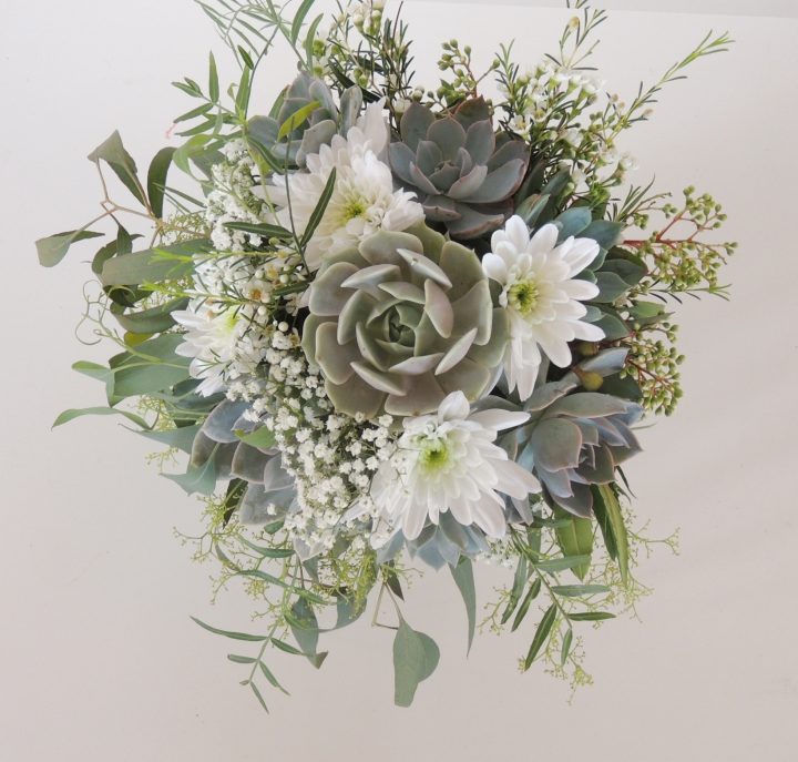 Succulent bridal bouquet with eucalyptus for spray effect.