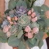 Succulent bouquet with pink spray roses, and silver dollar eucalyptus.