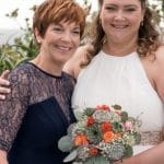 Succulent bouquet with orange spray roses and eucalyptus.